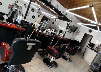 Interior estilizado de Astu Barber en Pérez, Santa Fe, AR, mostrando sillas de barbería clásicas y decoración moderna.