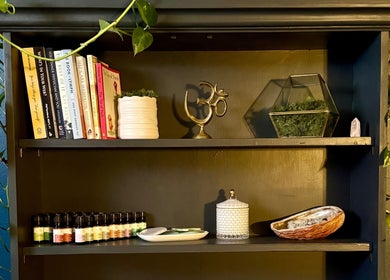 Tranquil shelf decor with books and oils at Be Well Bozeman, Bozeman, Montana, US for a serene environment.