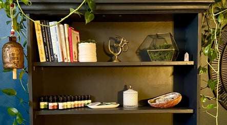 Tranquil shelf decor with books and oils at Be Well Bozeman, Bozeman, Montana, US for a serene environment.