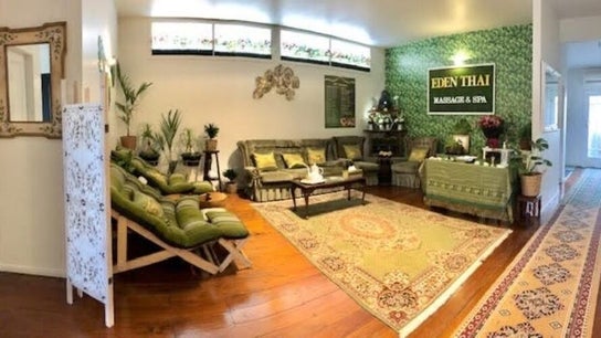 Cozy interior of Eden Thai Massage & Spa - Kingsland, Auckland, NZ featuring lush green decor and elegant seating.