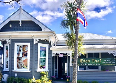 Eden Thai Massage & Spa - Kingsland in Auckland, NZ. Elegant grey exterior with palm and flag, inviting ambiance.