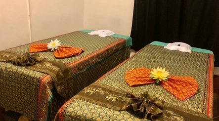 Luxurious massage beds at Eden Thai Massage & Spa - Mount Eden, Auckland, NZ adorned with flowers for relaxation.