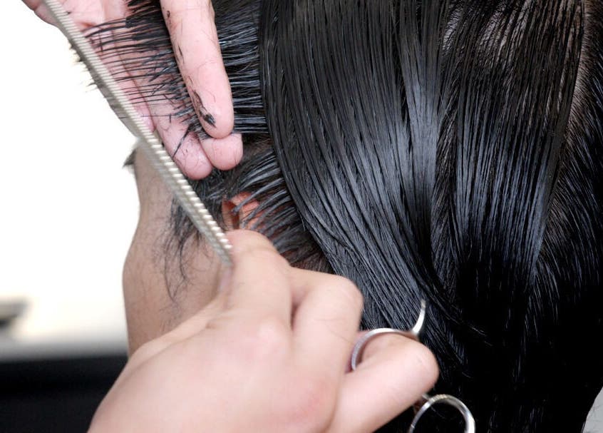 A stylist cuts hair at Whistle & Flute Barber Studio, Auckland, Auckland, NZ, showcasing expert hair techniques.