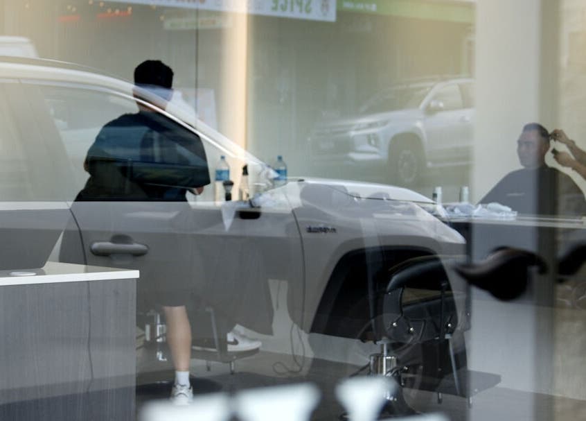 Barber working at Whistle & Flute Barber Studio, Auckland, NZ, in a stylish urban setting.