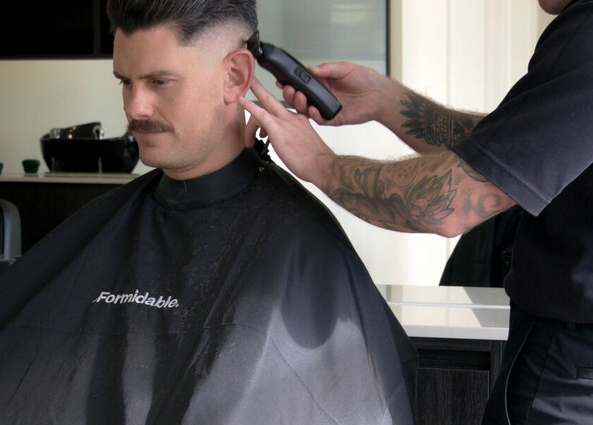 Haircut at Whistle & Flute Barber Studio, Auckland, Auckland, NZ. Barber using clippers for a modern style.