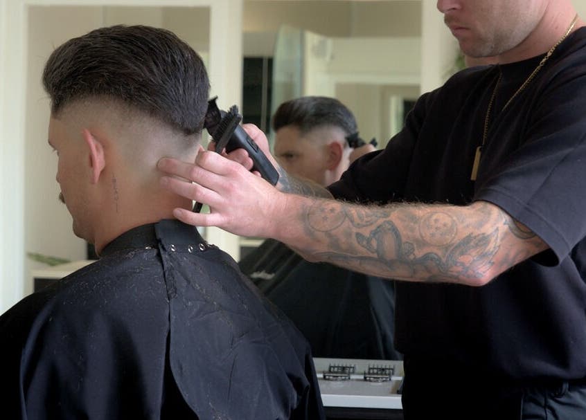 Barber expertly trims client's hair at Whistle & Flute Barber Studio, Auckland, Auckland, NZ.