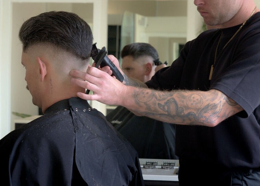 Barber expertly trims client's hair at Whistle & Flute Barber Studio, Auckland, Auckland, NZ.