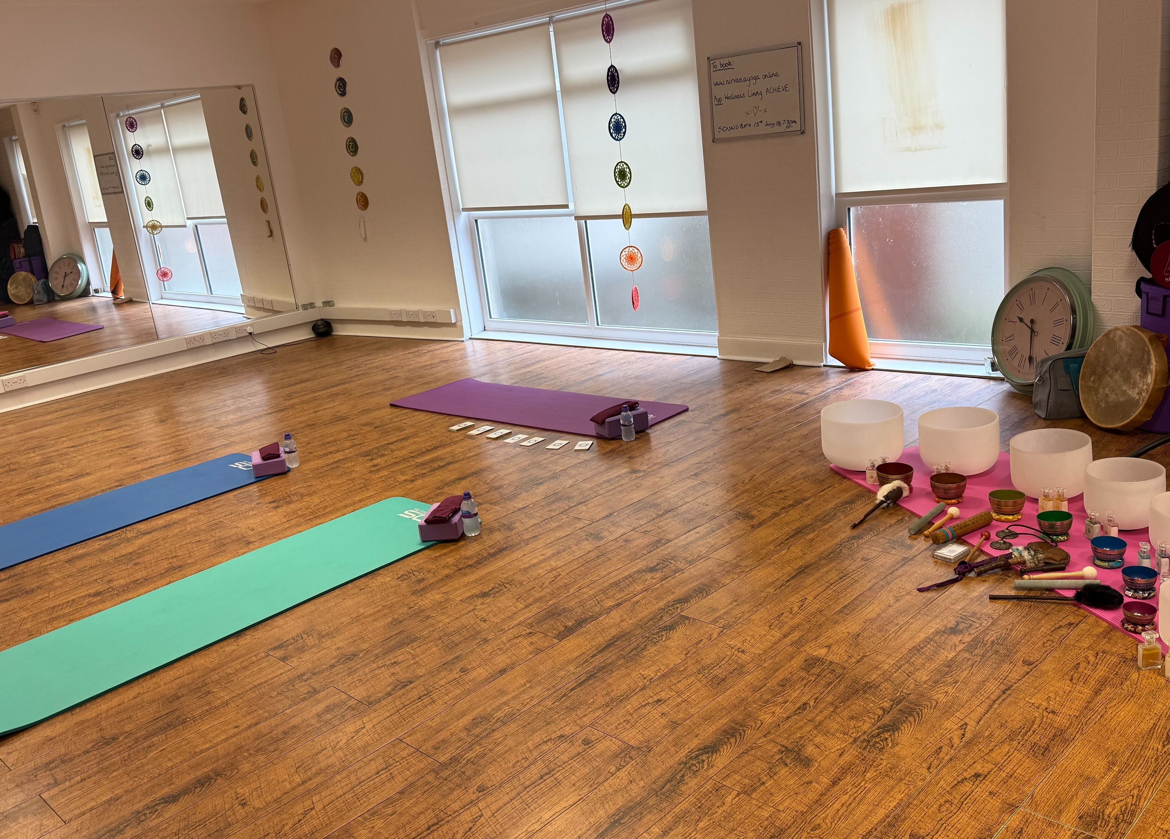 Peaceful yoga studio at Dhyan Jyoti-Eir, Lanark, Scotland, GB with mats, singing bowls, and gongs for meditation.