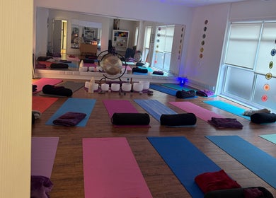 Yoga mats and cushions arranged in a tranquil studio at Dhyan Jyoti-Eir, Lanark, Scotland, GB.