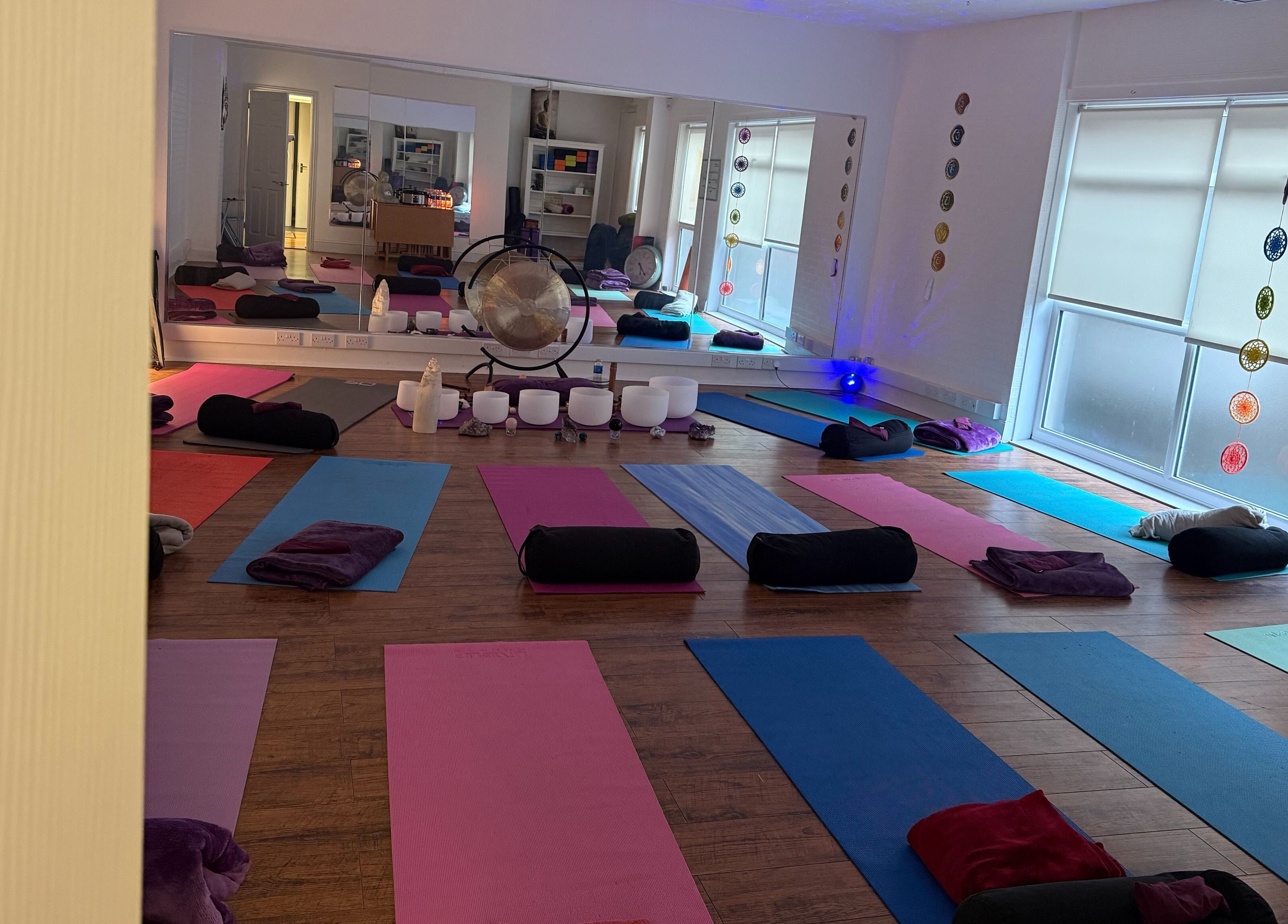 Yoga mats and cushions arranged in a tranquil studio at Dhyan Jyoti-Eir, Lanark, Scotland, GB.