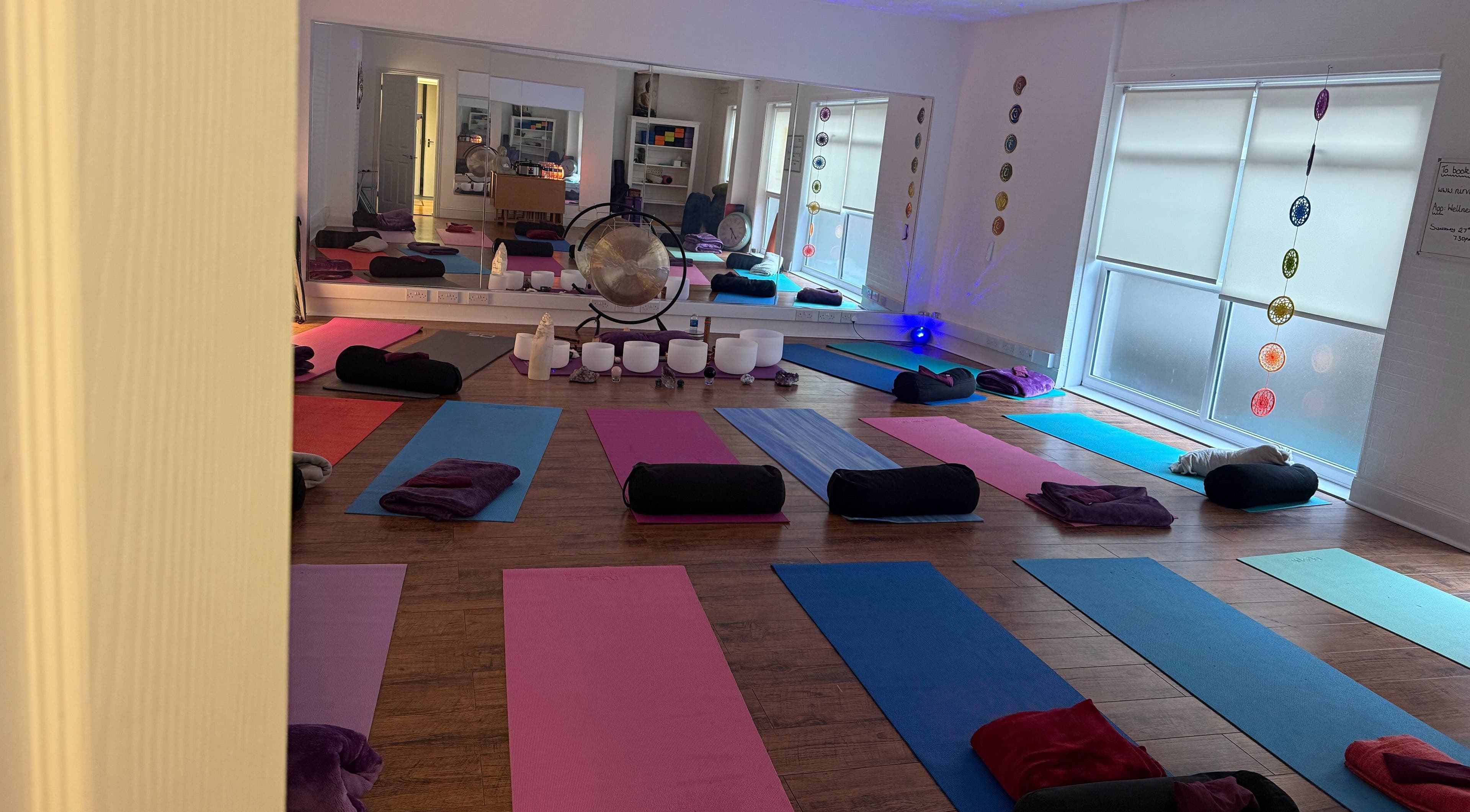 Yoga mats and cushions arranged in a tranquil studio at Dhyan Jyoti-Eir, Lanark, Scotland, GB.