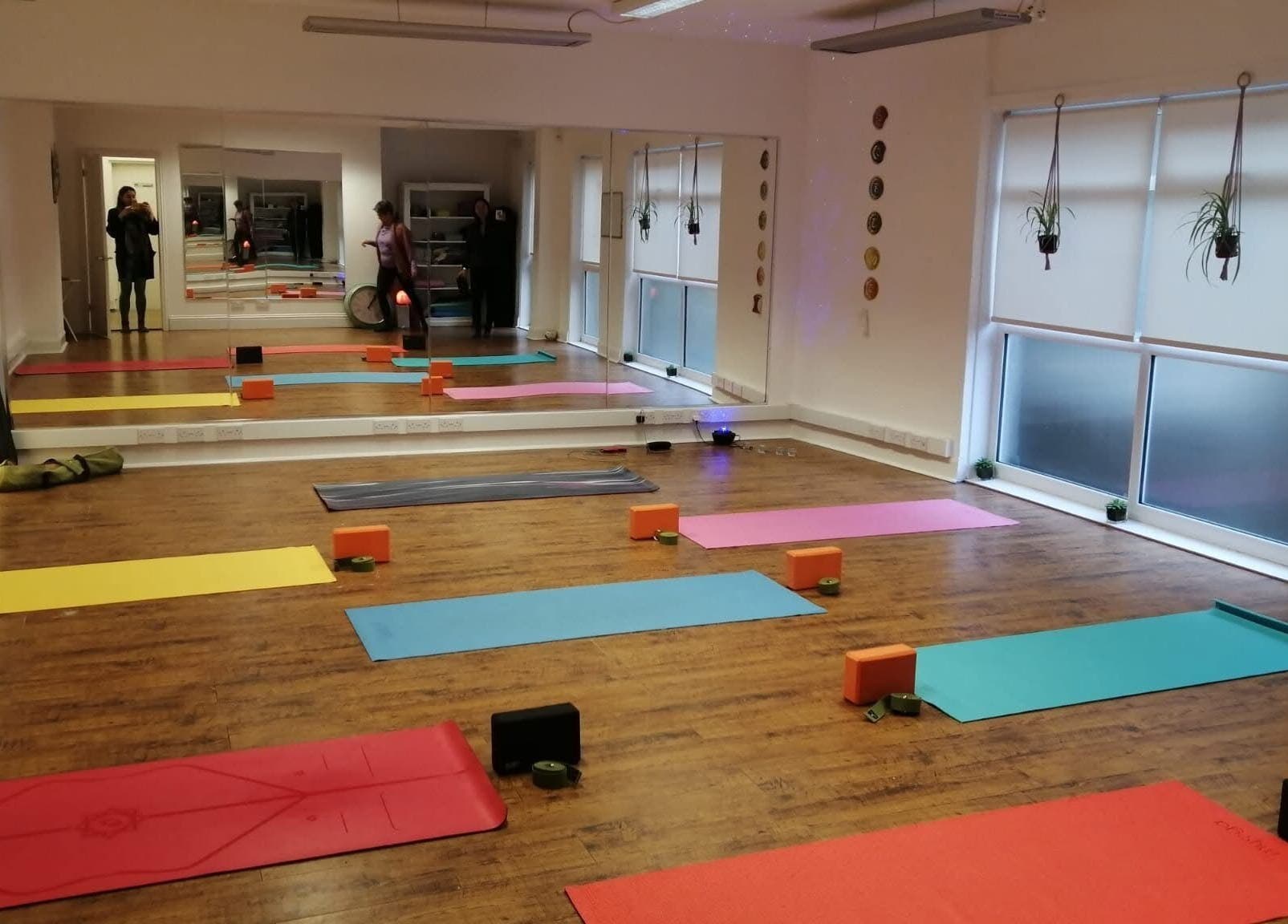Yoga studio at Dhyan Jyoti-Eir, Lanark, Scotland, GB, with colorful mats and tranquil ambiance.