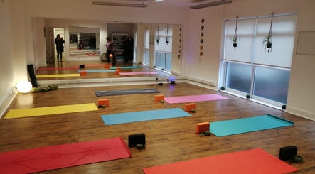 Yoga studio at Dhyan Jyoti-Eir, Lanark, Scotland, GB, with colorful mats and tranquil ambiance.