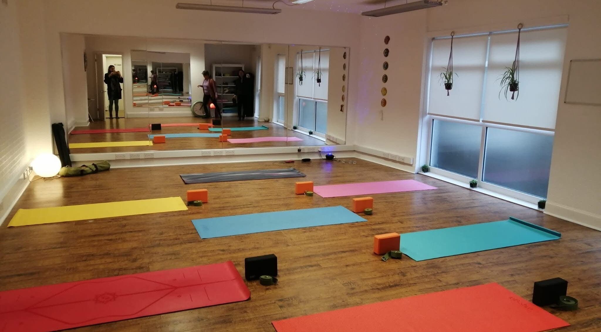 Yoga studio at Dhyan Jyoti-Eir, Lanark, Scotland, GB, with colorful mats and tranquil ambiance.