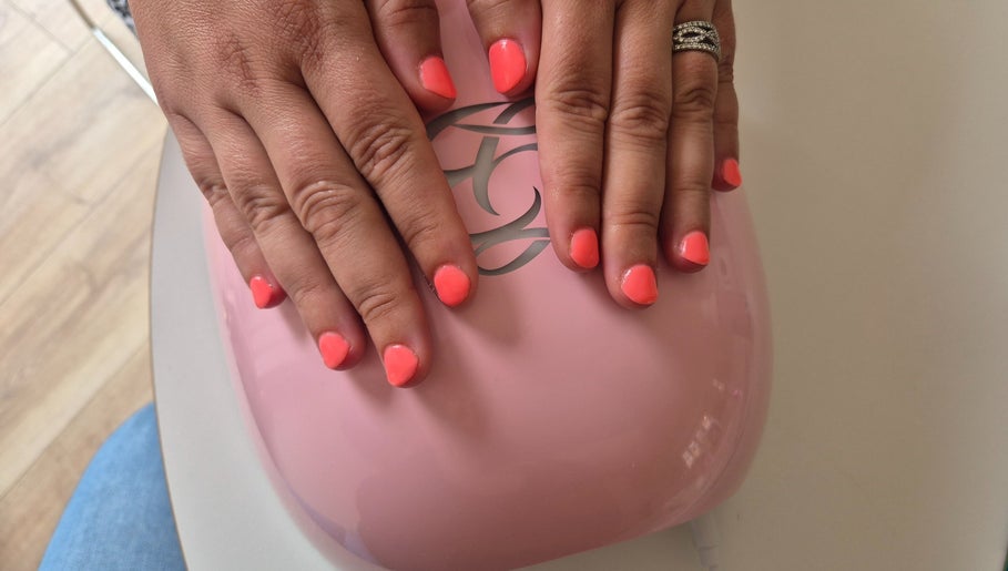 Bright coral nails under LED at Nails with Carly, Great Bookham, England, GB for a chic look.