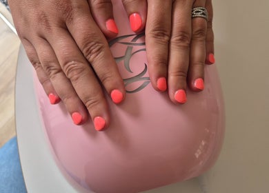 Bright coral nails under LED at Nails with Carly, Great Bookham, England, GB for a chic look.