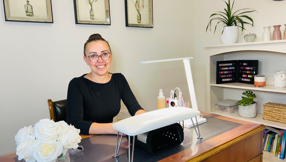 Friendly nail technician at Anna Paints Nails in Bracon Ash, England, GB, ready to assist clients.