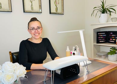 Friendly nail technician at Anna Paints Nails in Bracon Ash, England, GB, ready to assist clients.