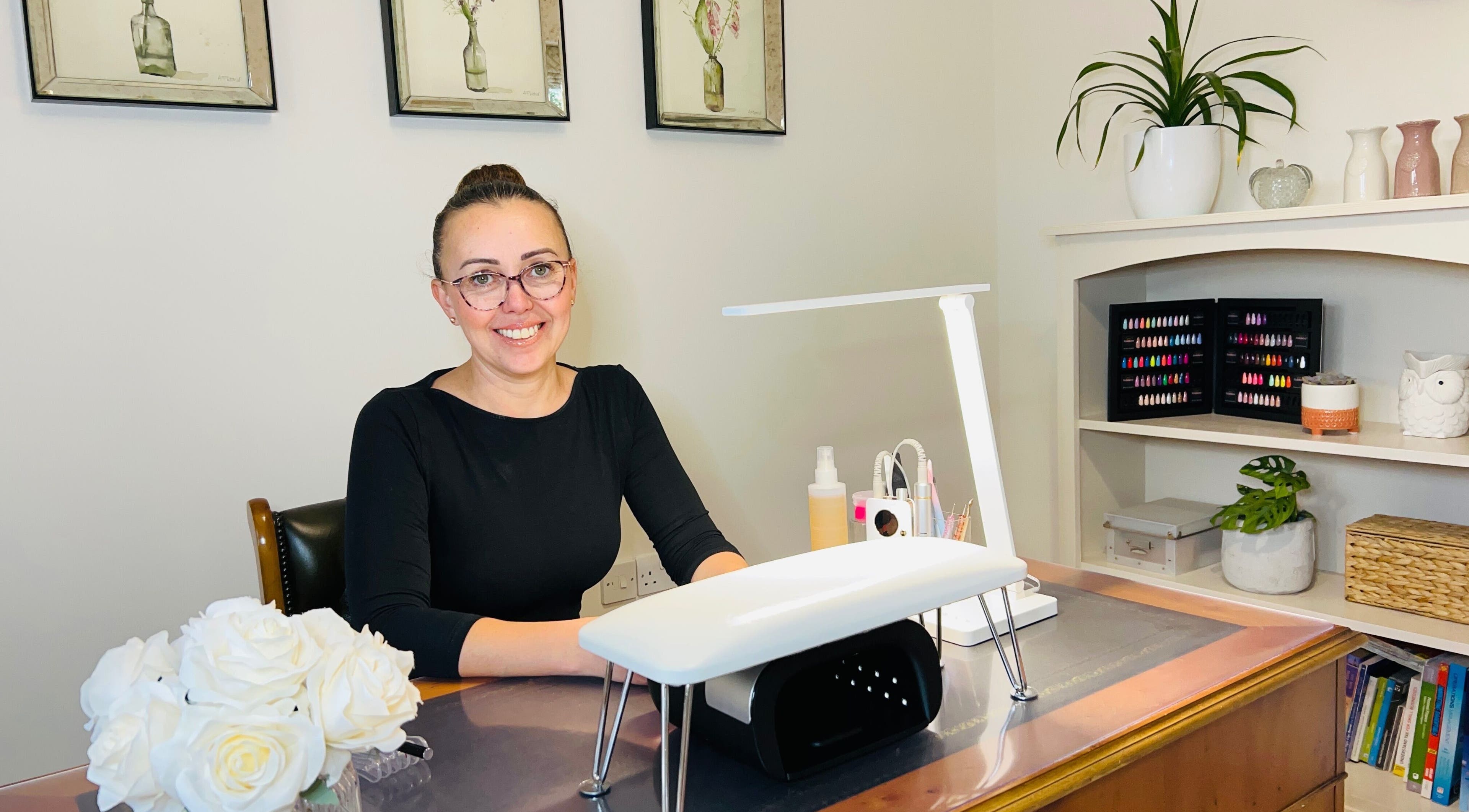 Friendly nail technician at Anna Paints Nails in Bracon Ash, England, GB, ready to assist clients.