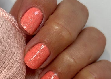Coral nails with shimmer at Anna Paints Nails in Bracon Ash, England, GB.