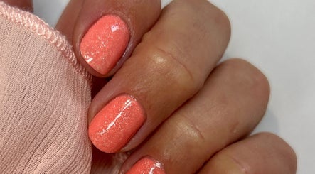 Coral nails with shimmer at Anna Paints Nails in Bracon Ash, England, GB.