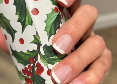 Elegant French manicure with festive design at Anna Paints Nails in Bracon Ash, England, GB.