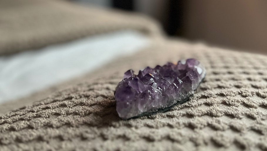Amethyst crystal on a textured blanket at Earth Glow Holistic Wellness, Preston, England, GB.