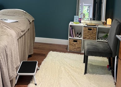 Cozy massage room at Earth Glow Holistic Wellness in Preston, England, GB with soft lighting and plush decor.
