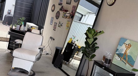 Barber chair in TheGarageChair, Port Adelaide, South Australia, AU, displaying vintage decor and lush plants.