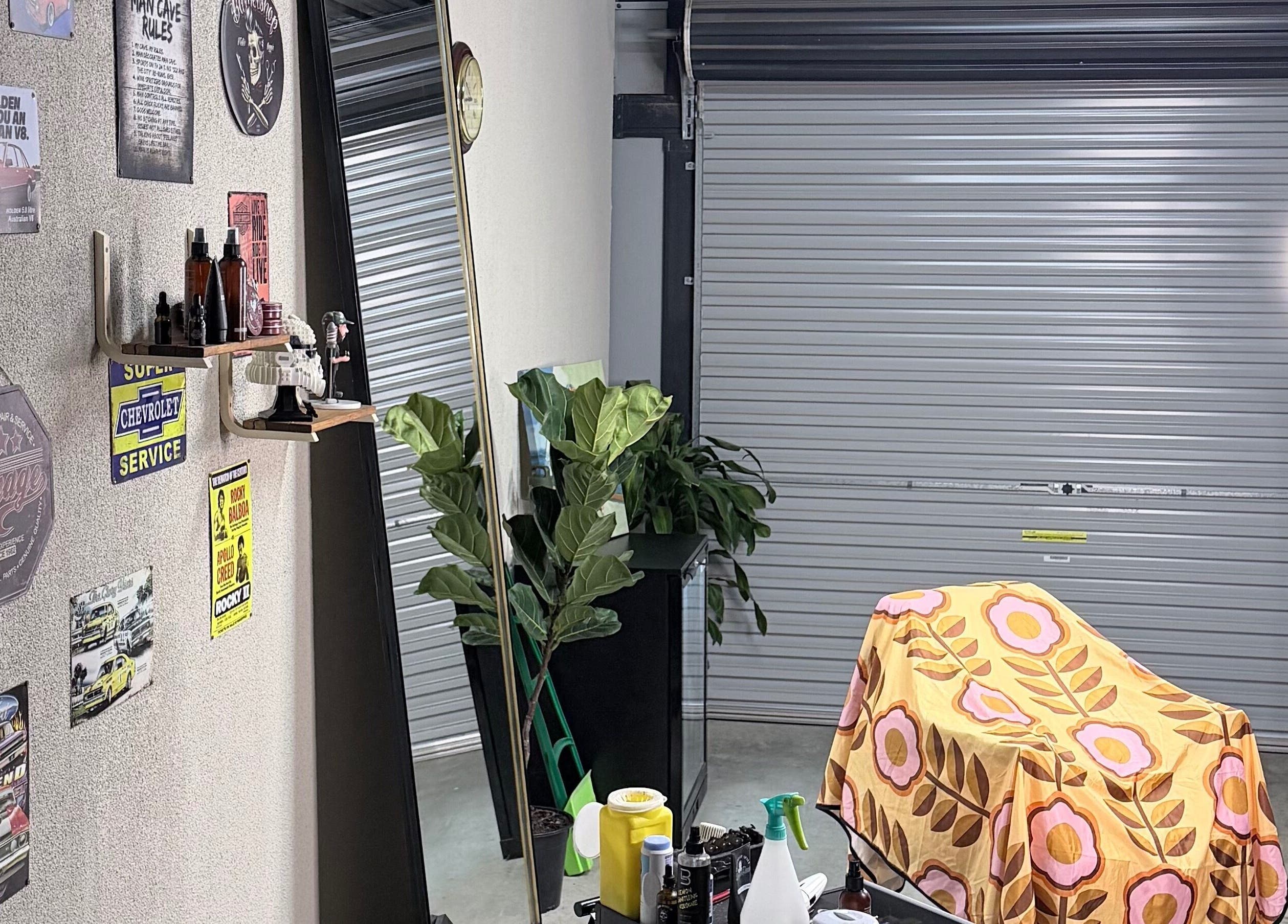 Stylish beauty setup at TheGarageChair, Port Adelaide, South Australia, adorned with retro signs and modern decor.