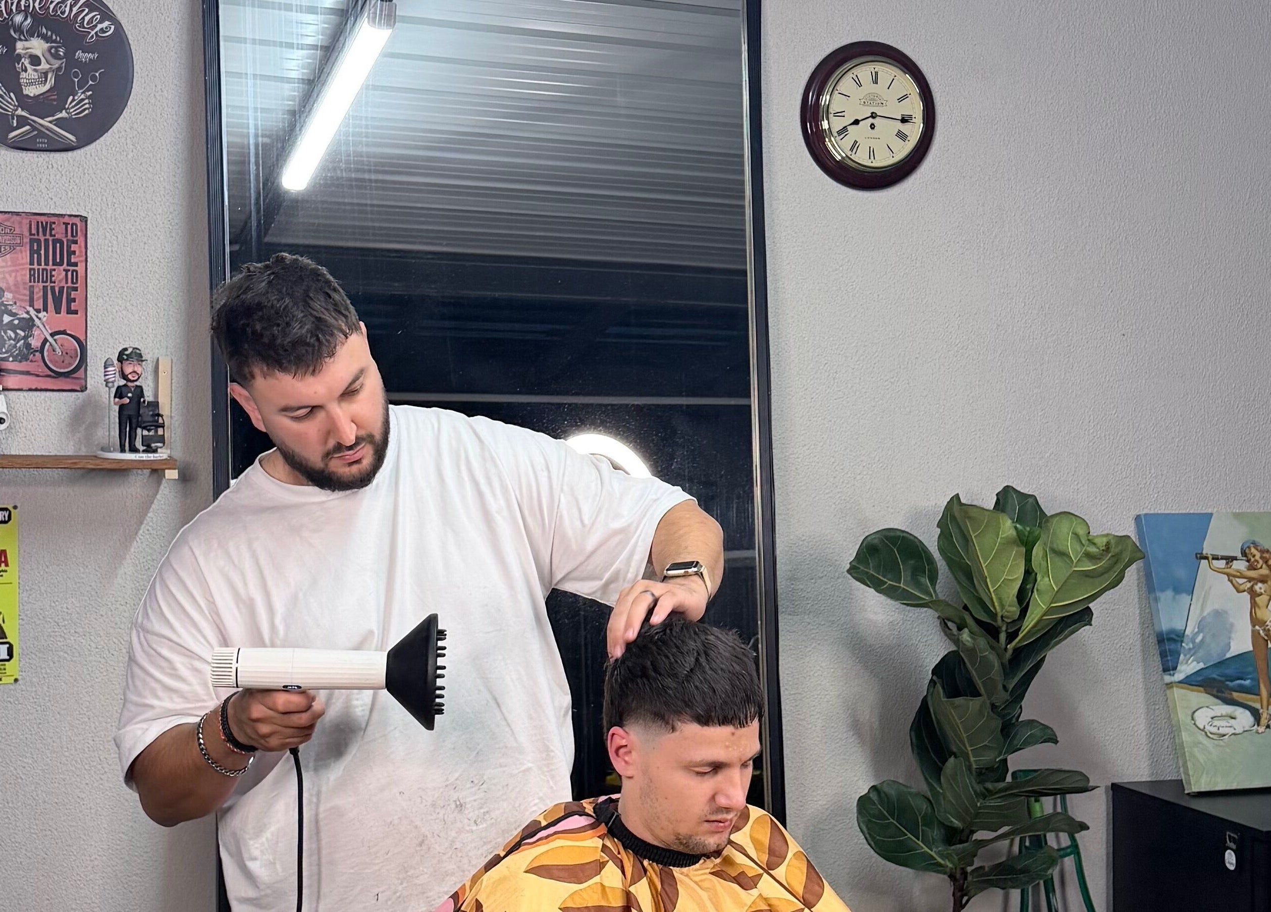 Hairdresser styling at TheGarageChair in Port Adelaide, South Australia, AU. Cozy, modern interior.