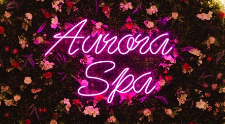 Neon sign 'Aurora Spa' with floral backdrop at Aurora Muslimah Salon & Spa Bukit Rimau, Shah Alam, Selangor, MY.