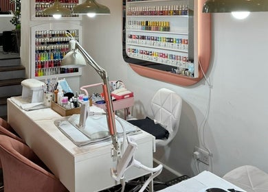 Elegant nail station at Lyttle Minx II Nails & Beauty, London, England, GB. Modern decor with diverse polish selection.