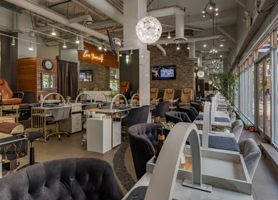 Spacious interior of La Lotus Nails Spa in Vancouver, British Columbia, CA with elegant decor and seating.