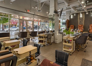 Interior of La Lotus Nails Spa, Vancouver, BC, showcasing elegant nail stations and pedicure chairs.