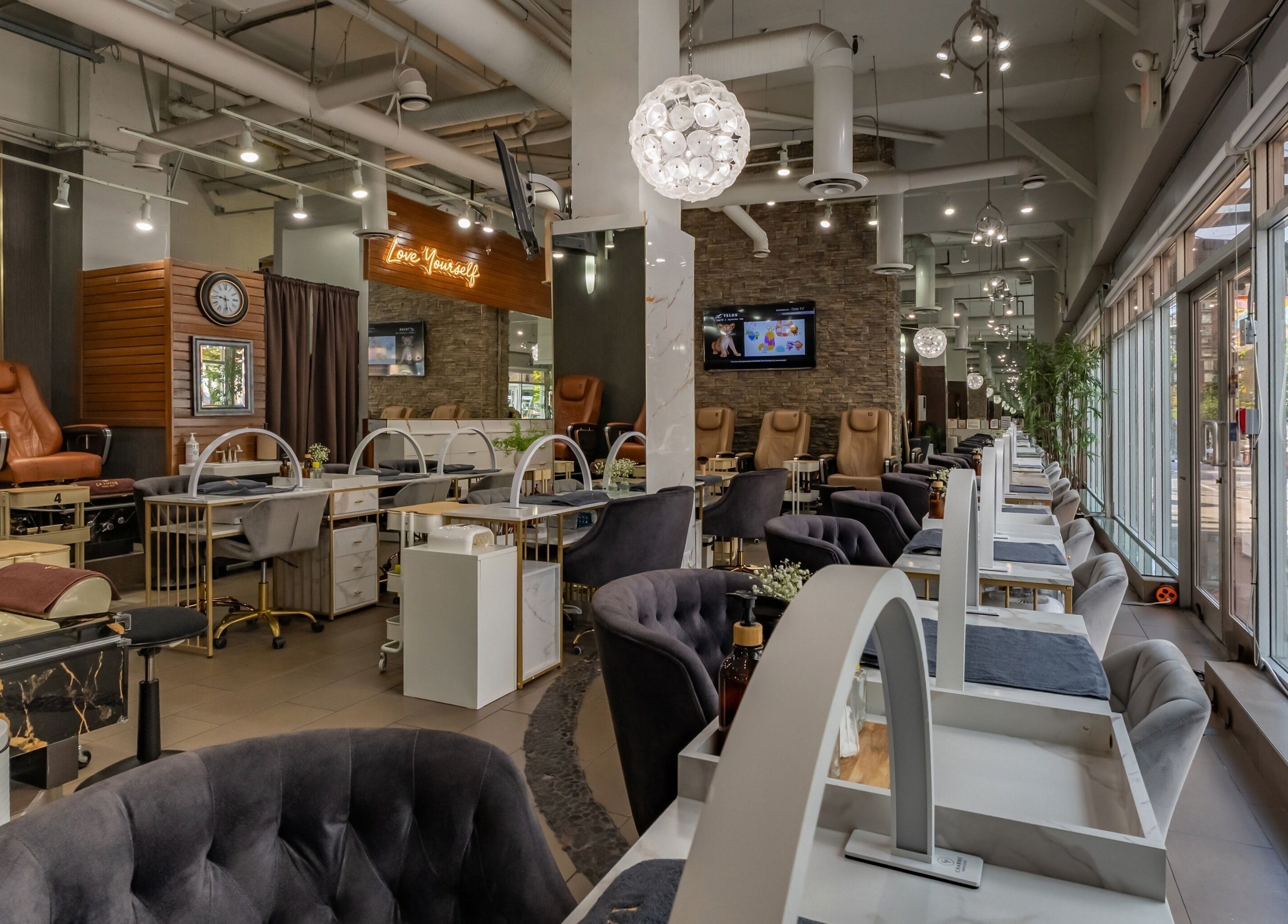Interior of La Lotus Nails Spa, Vancouver, British Columbia, CA, featuring modern nail stations and plush chairs.