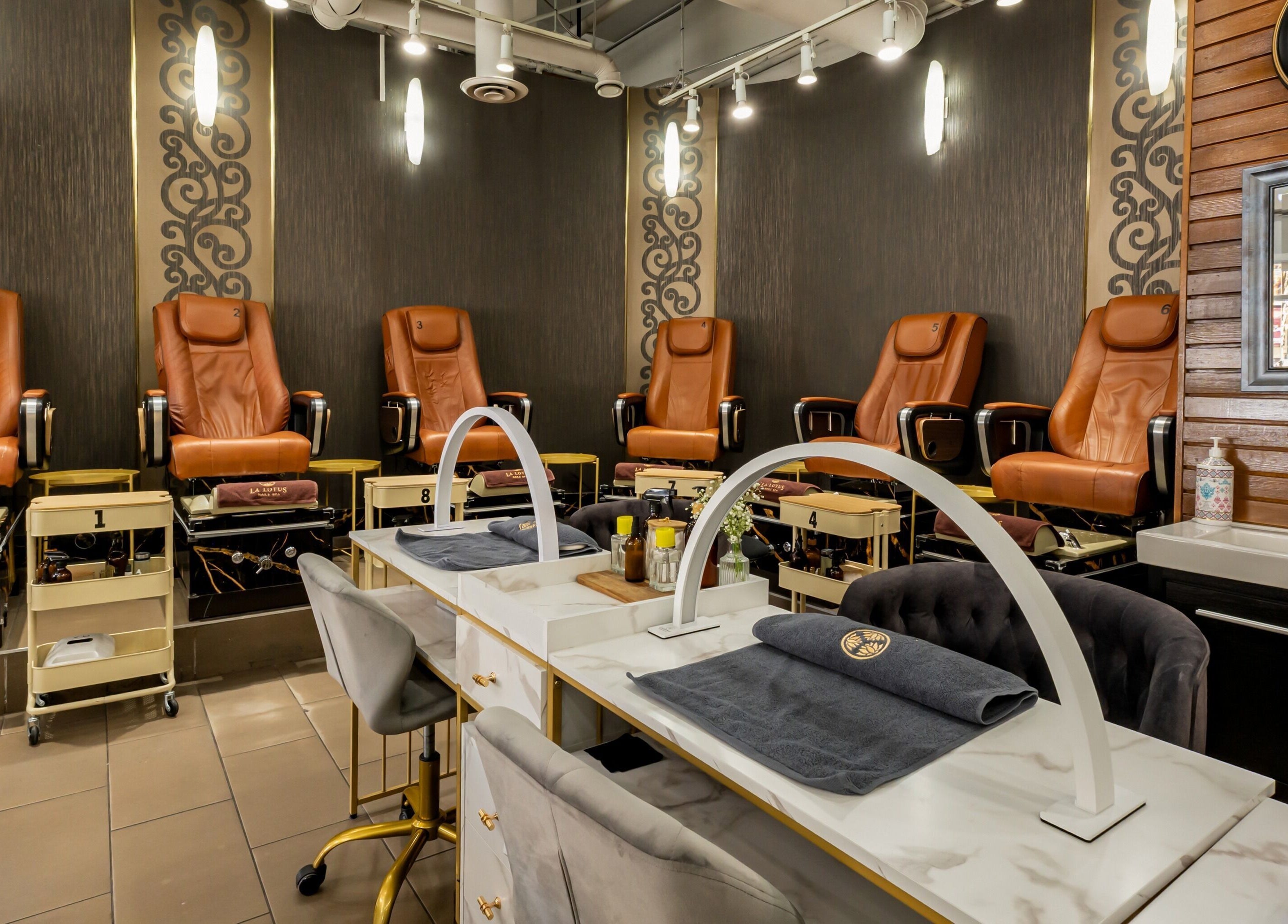 Chic interior of La Lotus Nails Spa in Vancouver, British Columbia, CA showcasing elegant pedicure stations.