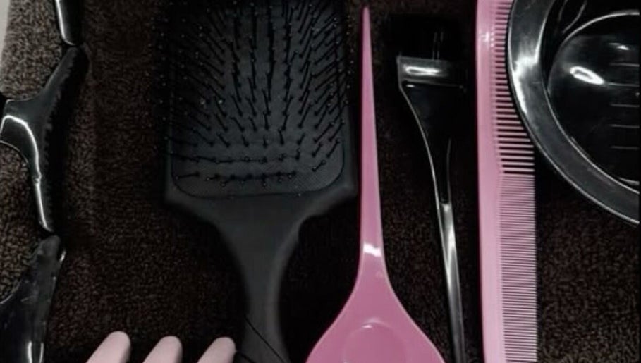 Hairbrush, comb, and clips at Slayedbyajblacc salon, Bristol, England, GB.