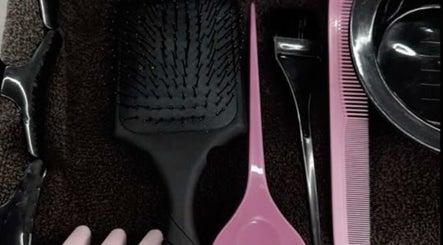 Hairbrush, comb, and clips at Slayedbyajblacc salon, Bristol, England, GB.