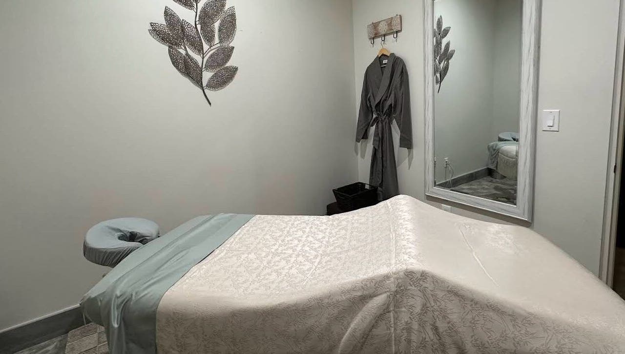 Tranquil massage room at Strength & Touch Gym in Houston, Texas, US with massage table and wall decor.