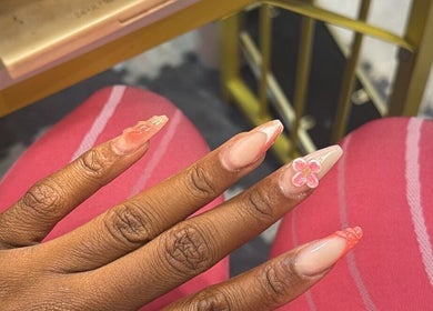 Nail art with pink floral design at The Pink Edit Co., London, England, GB showcasing creative manicure.