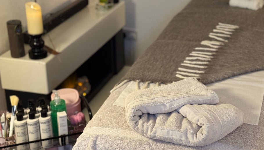 Relaxing spa ambiance at Allure Beauty By Yazmine, London, England, GB showcasing cozy blankets and skincare products.