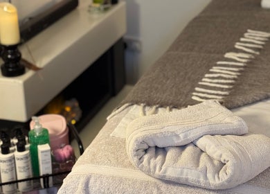 Relaxing spa ambiance at Allure Beauty By Yazmine, London, England, GB showcasing cozy blankets and skincare products.