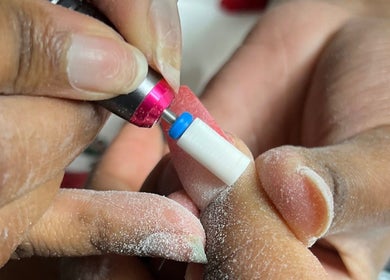 Close-up of a nail drill at Lu_Nailedit, Sheffield, England, GB, showcasing expert manicure techniques.
