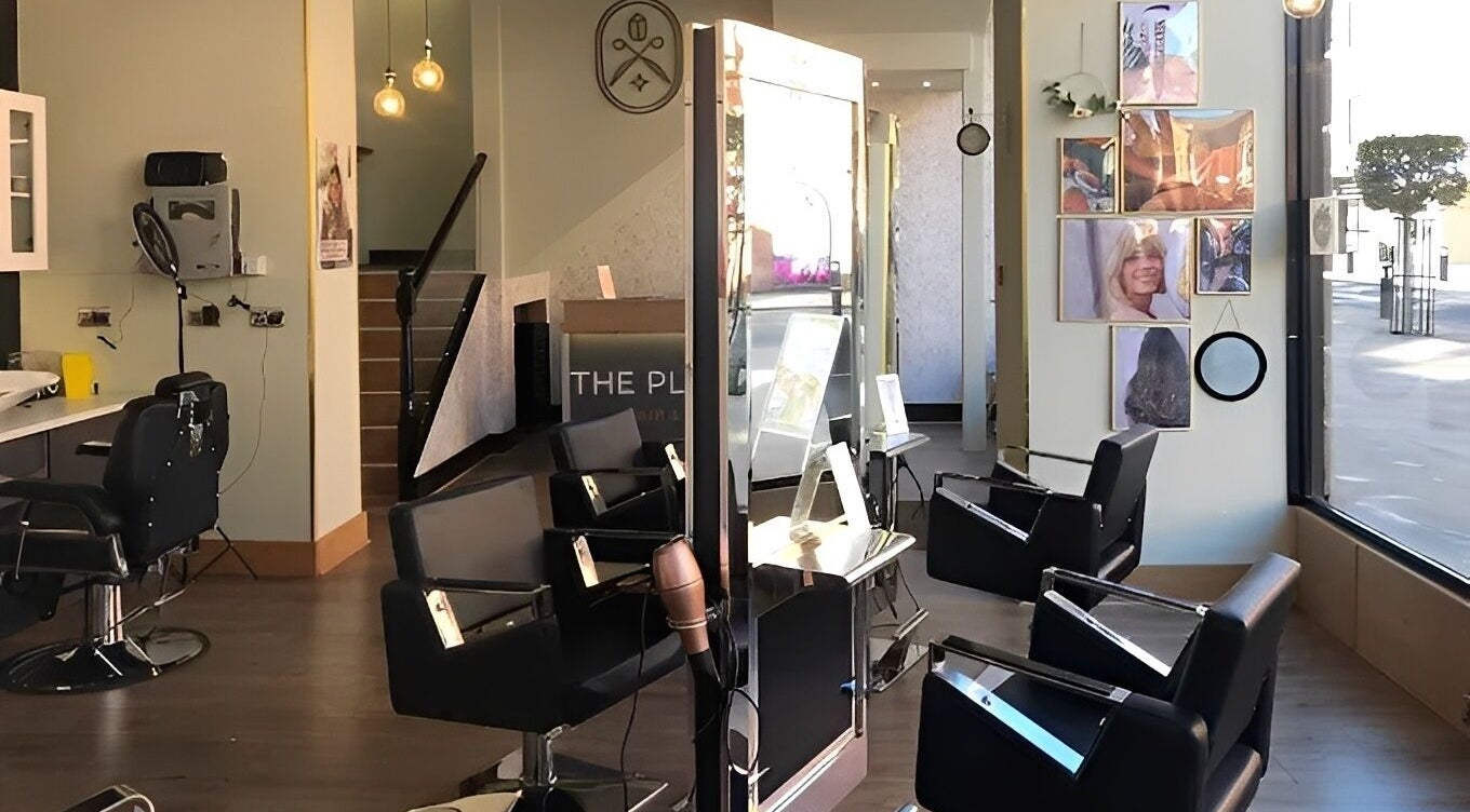 Interior view of The Place Hair & Beauty salon in Bolton, England, GB with stylish chairs and modern decor.