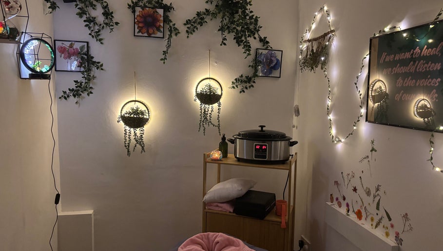Warm, cozy massage room at A.M.B.E.R Aromatherapy and Massage, Dalkeith, Scotland, GB, featuring illuminated decor.