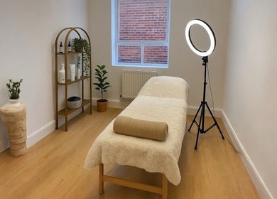 Calm treatment room at Glow Method Crawley, Crawley, England, GB featuring a cozy massage bed and warm decor.
