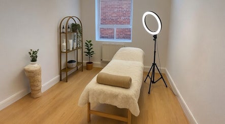 Calm treatment room at Glow Method Crawley, Crawley, England, GB featuring a cozy massage bed and warm decor.