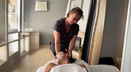 Therapist providing massage at Glow Method Crawley, elegant setting, Crawley, England, GB.
