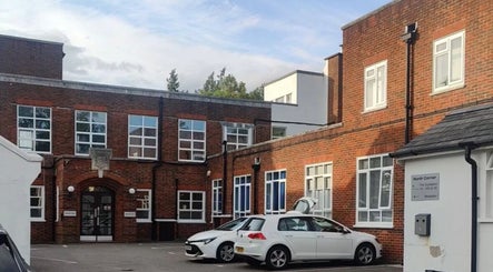Glow Method Crawley exterior in Crawley, England, GB with classic brick facade and parking area.